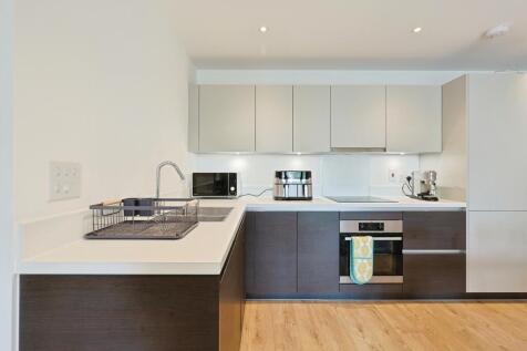 A modern, clean kitchen area featuring sleek ca...
