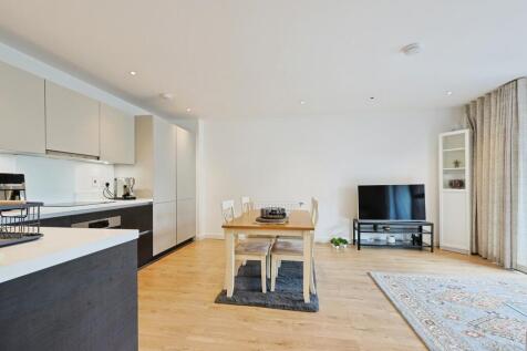 Bright and modern living room featuring a spaci...