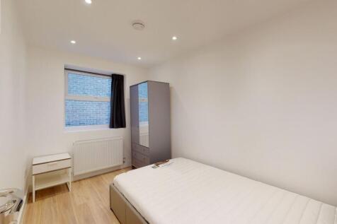 A neat and modern single bedroom featuring a co...
