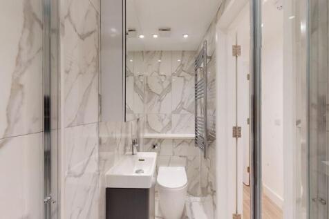 Bright and modern bathroom featuring elegant ma...