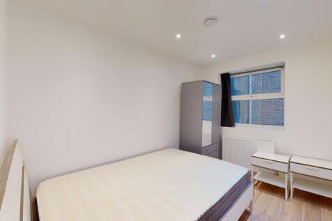 A neat and modern double bedroom featuring a co...