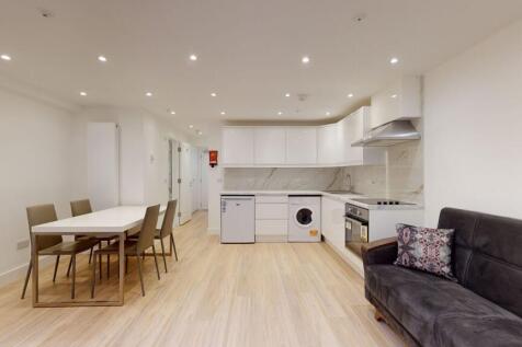 Bright and modern kitchen and dining area featu...