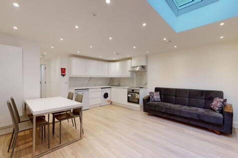 A modern, open-plan living room with a sleek wh...