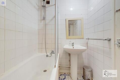 Clean and functional bathroom with a bathtub, s...