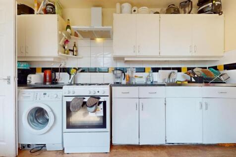A compact kitchen featuring essential appliance...