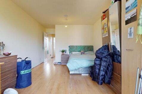 A neatly arranged double bedroom with a comfort...