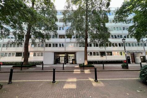 Modern residential building front with large wi...