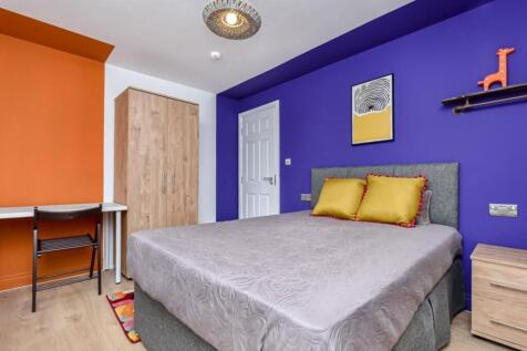 A bright and colorful double bedroom featuring ...