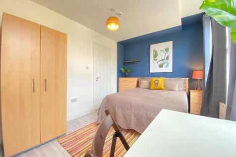 Bright and welcoming master bedroom featuring a...