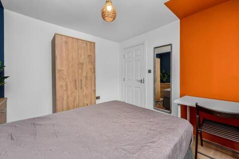 A bright and welcoming double bedroom featuring...