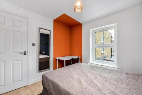 Bright and inviting bedroom with a large window...