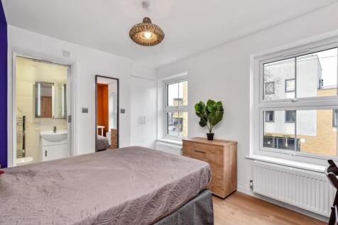 Bright and well-maintained bedroom with two lar...