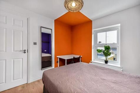 A bright and modern double bedroom featuring a ...
