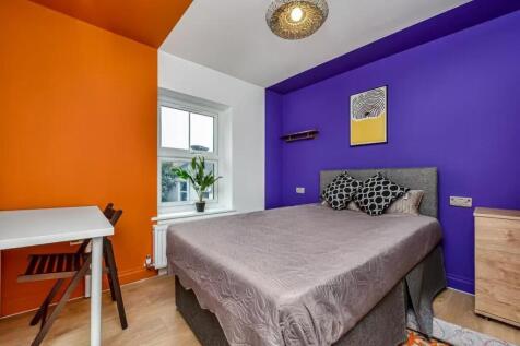 A vibrant bedroom featuring a striking color co...