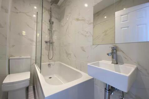 Modern and sleek bathroom featuring a spacious ...