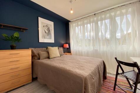 A cozy and well-lit double bedroom featuring a ...