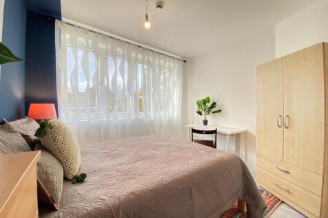Bright and welcoming double bedroom featuring a...