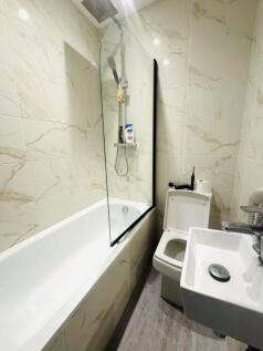 A modern, well-maintained bathroom with a large...