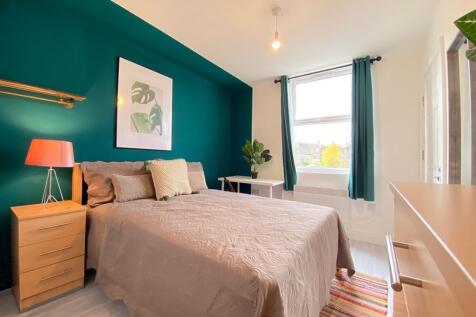 Bright and welcoming double bedroom featuring a...