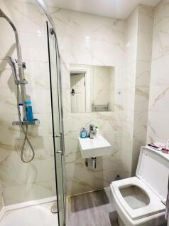 Modern bathroom featuring a walk-in shower with...