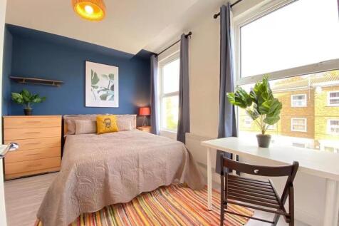 Bright, welcoming bedroom with modern decor, fe...