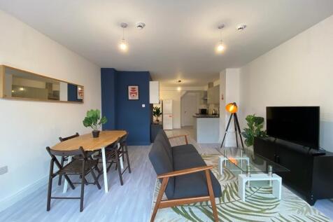 Modern and spacious living area featuring a com...