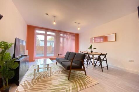 Bright and welcoming living room featuring a la...