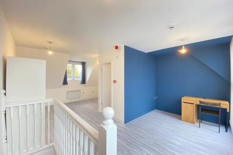 Bright, freshly painted upstairs bedroom with a...