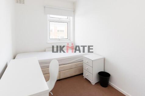 A bright and tidy small bedroom featuring a sin...