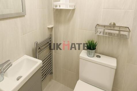 A modern, clean bathroom featuring a white toil...
