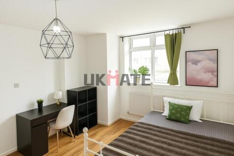 Bright and inviting bedroom featuring a cozy be...