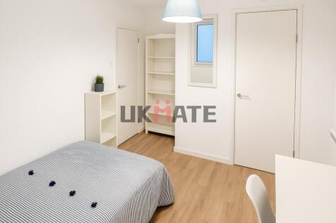 A bright and tidy bedroom with a comfortable be...