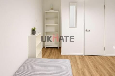Bright and clean bedroom featuring a comfortabl...
