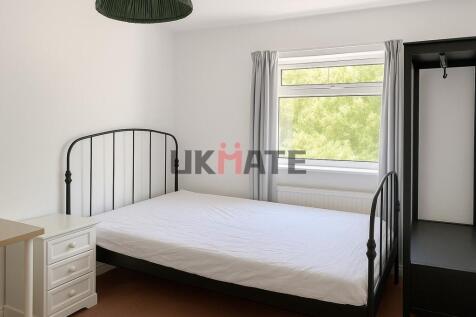 Bright and welcoming bedroom with a comfortable...