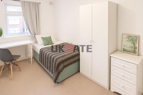 A bright, inviting single bedroom with a comfor...