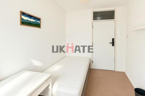 A bright and clean double bedroom with a simple...