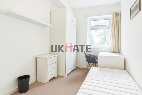 A bright and tidy single bedroom featuring a co...