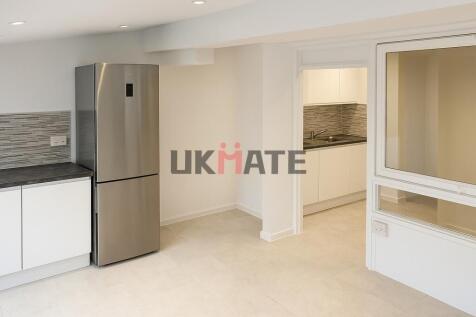 Modern and sleek kitchen with clean white cabin...