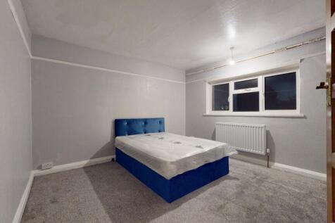A spacious and well-lit master bedroom featurin...