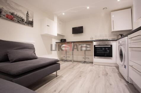 A modern and tidy living area featuring a comfo...