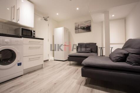 A modern, well-lit living room featuring comfor...