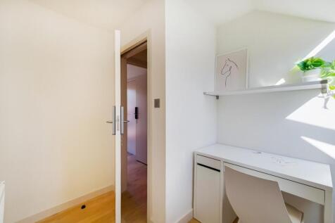 A bright and well-maintained bedroom featuring ...