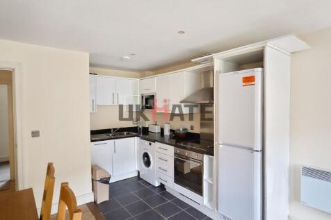 Modern and neatly organized kitchen with white ...