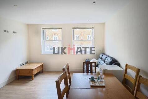 Bright and spacious living room with large wind...