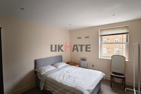 A bright and neatly maintained bedroom featurin...
