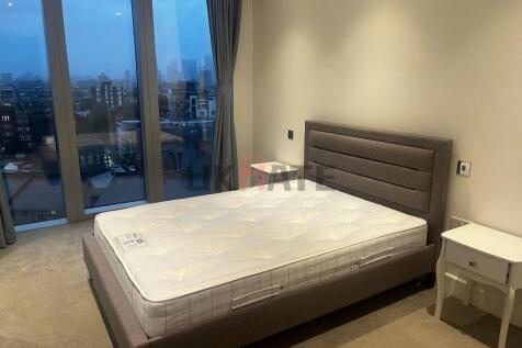 A spacious, modern bedroom with a large window ...