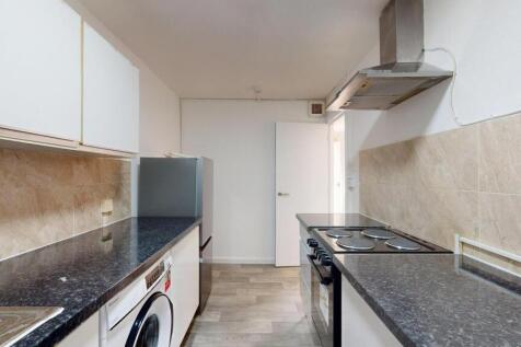 Well-maintained kitchen featuring black granite...