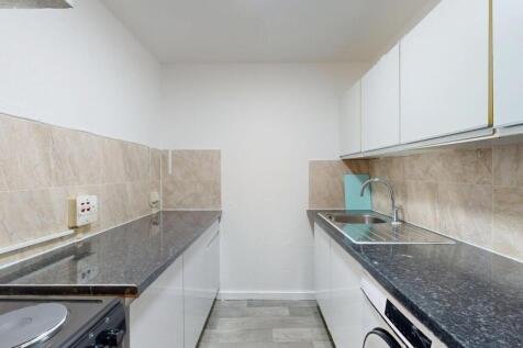A modern, tidy kitchen with granite countertops...