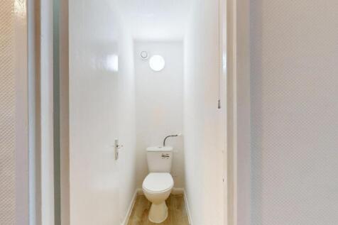 A clean, well-maintained bathroom with a white ...