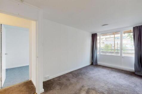 A spacious and bright living room with large wi...